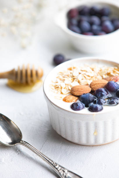 istock Yogurt bowl with oatmeal, almonds, blueberries and honey. 1465612497