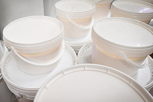 White plastic bucket with paint. . High quality photo