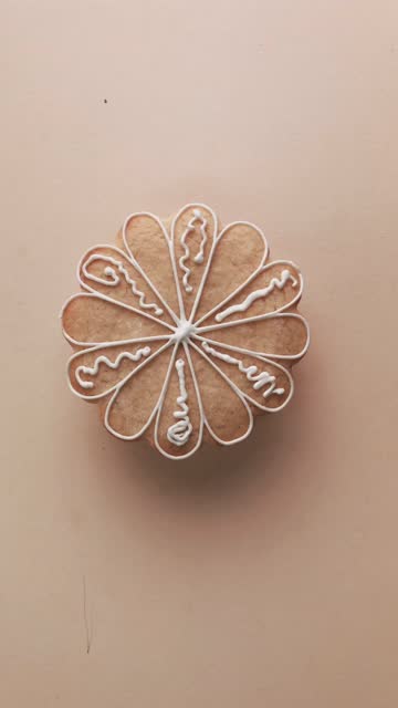 Icing cookies in the shape of a daisy flower.