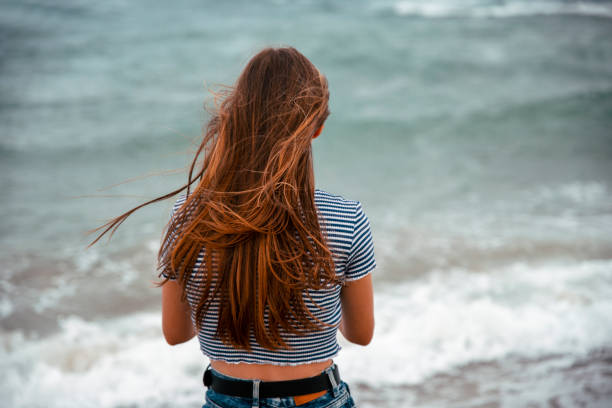 istock Beach wind in her hair 1465616194