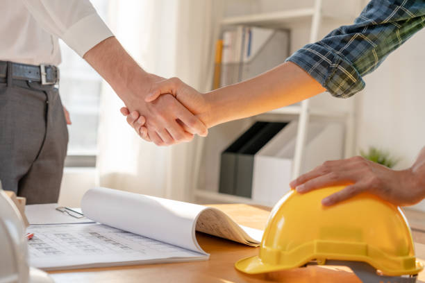 istock Construction worker team hands shaking greeting start up plan new project contract in office center at construction site, industry ,architecture, partner, teamwork, agreement, property, contacts. 1465616389