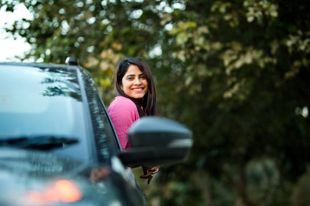 istock Cheerful woman looking out from car window 1465618301