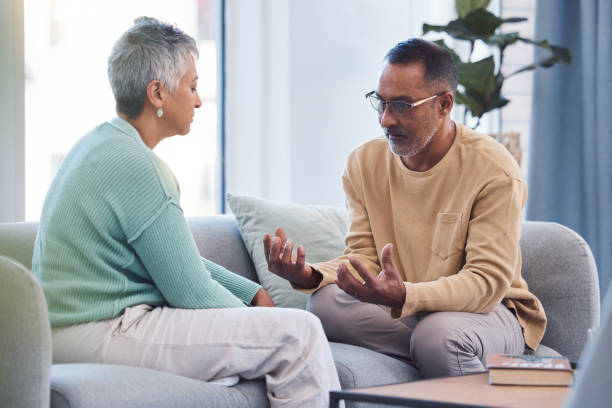 istock Couple, talking and conversation during fight on sofa about marriage problems, conflict and communication. Divorce, argument and frustrated relationship of mature man, woman and sad partner in lounge 1465619520