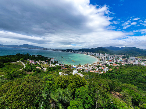 Itapema Bay seen from above. View from Mirante do Encanto. Itapema Beach. Coastal town surrounded by hills and forest. Santa Catarina. Brazil.
