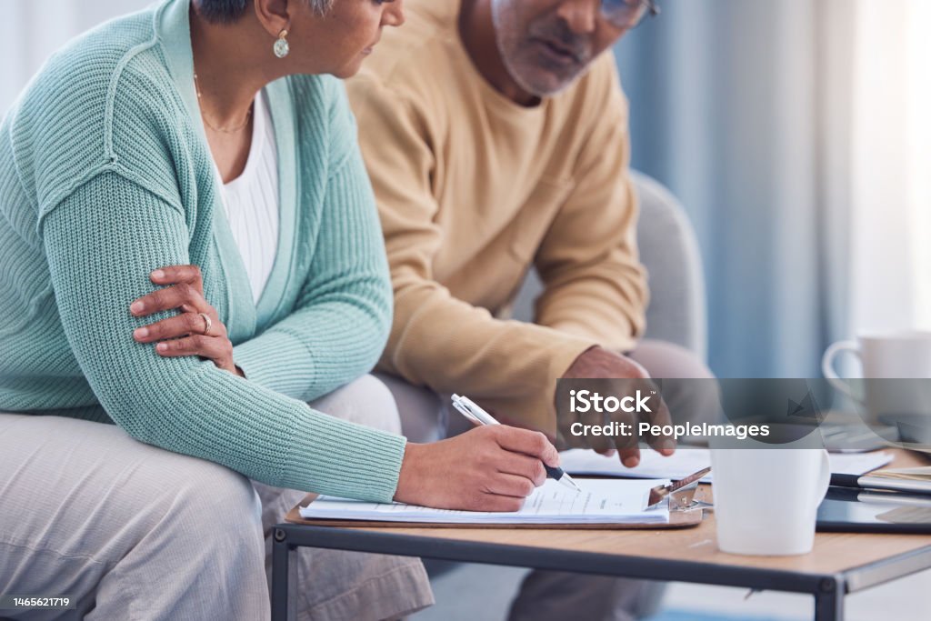 Senior couple, documents and sign contract for life insurance or home mortgage. Discussion, signature and retired elderly man and woman signing legal paperwork for will or loan application together. Will - Legal Document Stock Photo