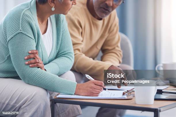Senior Couple Documents And Sign Contract For Life Insurance Or Home Mortgage Discussion Signature And Retired Elderly Man And Woman Signing Legal Paperwork For Will Or Loan Application Together Stock Photo - Download Image Now