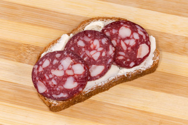 istock Open sandwich with smoked-cured sausage and butter close-up 1465622081