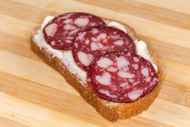 istock Open sandwich with smoked-cured sausage and butter close-up 1465622089