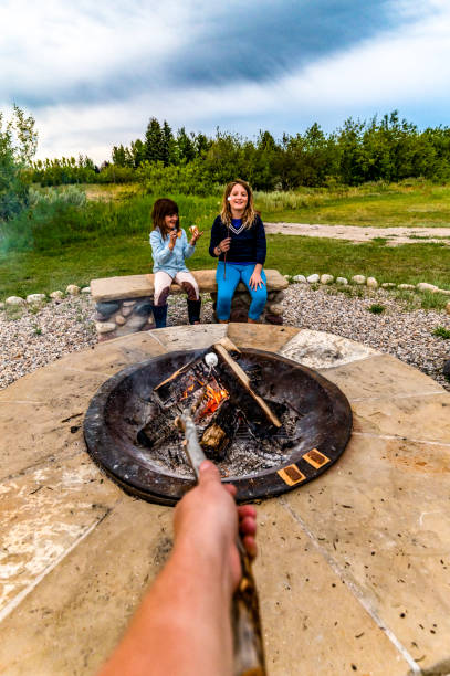 istock Cute kids roast marshmallows making s’mores over a campfire 1465625476