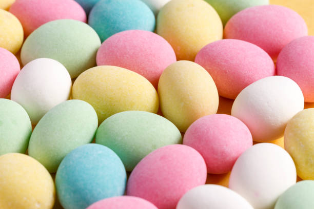 istock Pile of sweets on yellow background, top view 1465625679