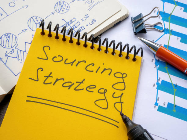 istock Page with handwritten sign sourcing strategy and papers. 1465625755