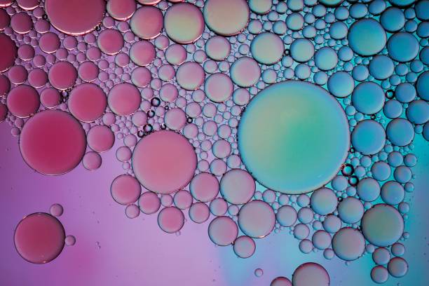 istock multi colored oil circles on the water, colorful background 1465626387