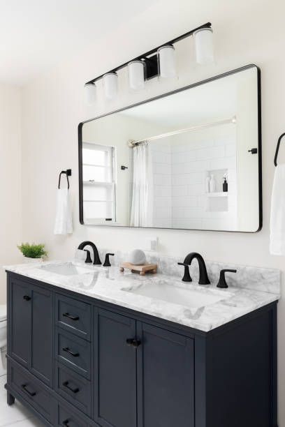 istock A bathroom with a blue cabinet and marble countertop. 1465626949