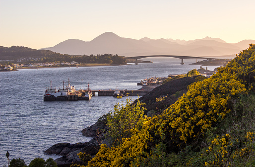 The Kyle of Lochalsh and the Isle of Skye, with the Skye Bridge in the background, at dawn. The name Kyle of Lochalsh comes from the gaelic Caol Loch Aillse, which means strait of the foaming loch, reffering to the narrow straight between Scotland and the Isle of Skye