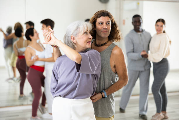 istock Elderly woman enjoying dancing in pair with expressive man 1465631605