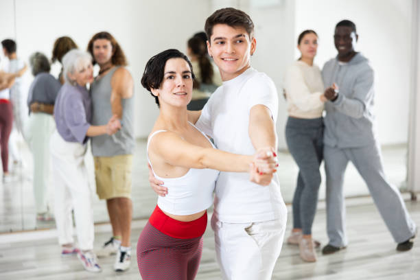 istock Hispanic woman and guy practicing slow ballroom dances in pair 1465631839
