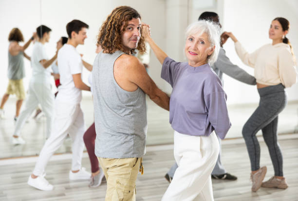 istock Smiling mature woman and man learning pair dances 1465631893
