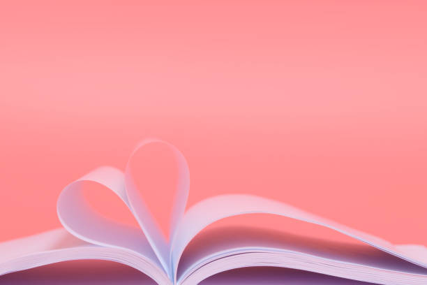 istock Book sheets in shape of heart isolated on pink background 1465631972