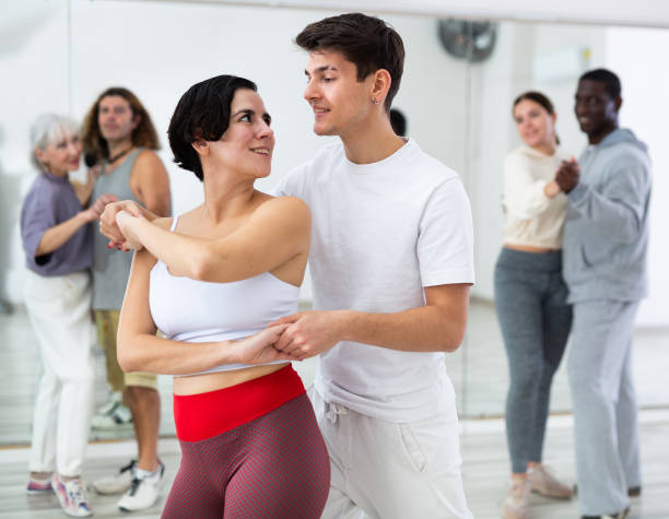istock Caucasian man and young woman learning paired latin dances 1465632334