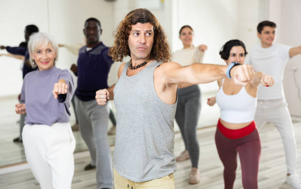 istock Happy caucasian man learning new modern dance in group dance lesson 1465632587