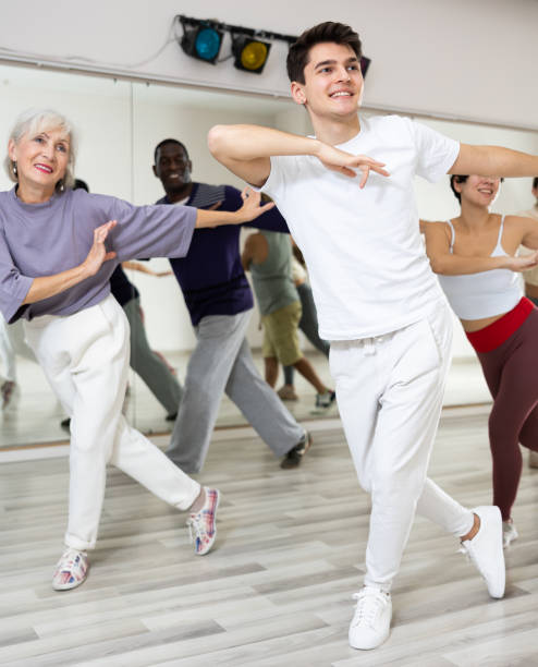 istock Caucasian man rehearsing modern dance with group in dance school 1465632660