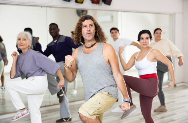 istock Happy caucasian man learning new modern dance in group dance lesson 1465632734