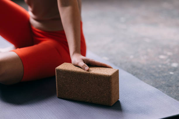 istock An Unrecognizable Sportswoman Doing Yoga Using A Wooden Brick 1465633775