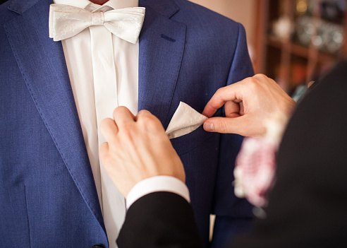 An elegant groom in a blue suit