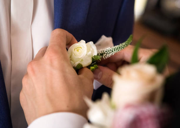 Pin a flower to the lapel of a jacket