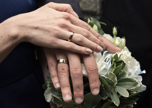 Hands of a young couple on a bouquet
