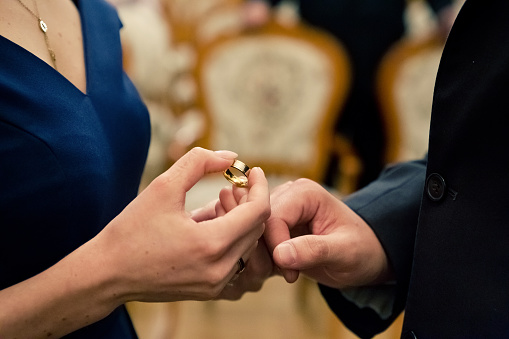 Gold wedding ring in the bride's hand