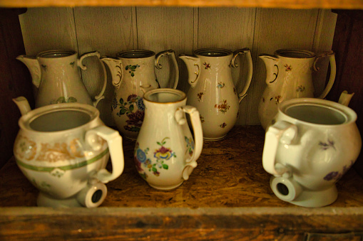 Collection of 22 retro cups of coffee decorated with flowers placed on a table