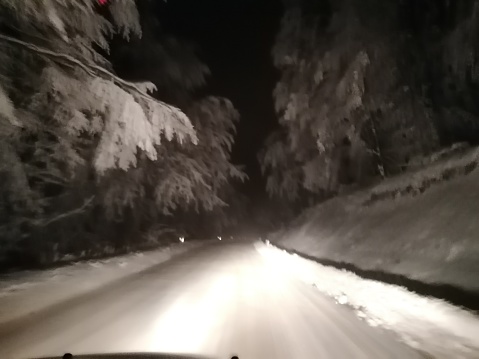 Night driving  on the mountain roads covered with a snow