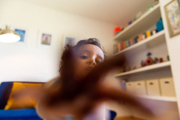 A girl made of plasticine on the background of a wet rainy window.