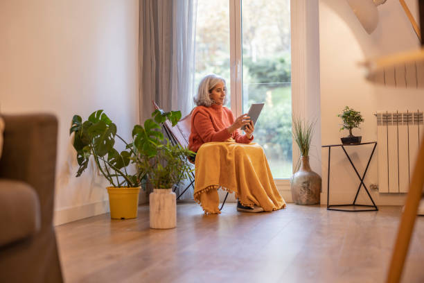 istock elderly woman uses tablet at home mature - Connectivity keeps her happy - 1465641663