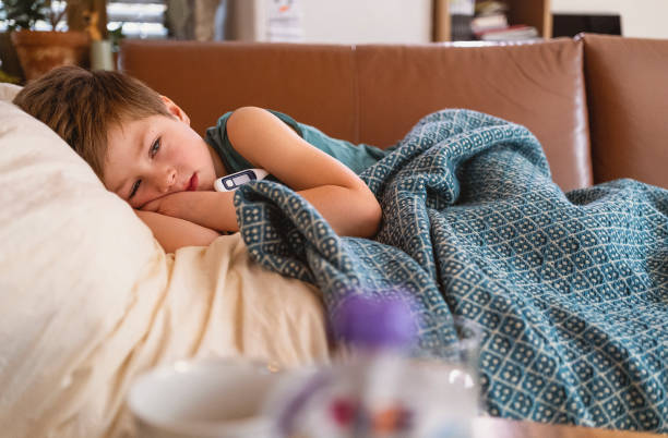 istock Sick little boy lying in bed 1465641701
