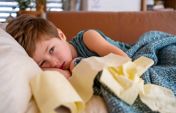 istock Sick little boy lying in bed 1465641702