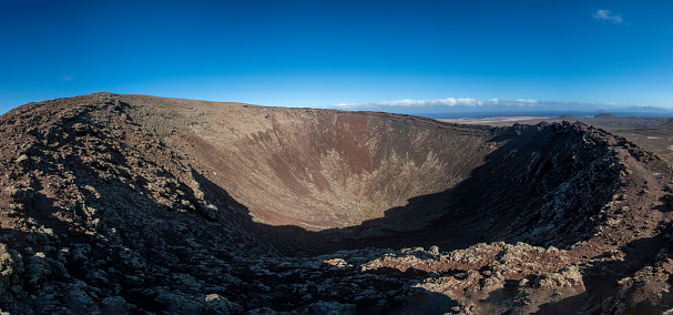 Panoramic view from the summit of Pico Viejo into the active crater. Volcanic barren desert terrain near Pico del Teide, Tenerife, Canary Islands, Spain, Europe. Solidified lava, ash, pumice on path