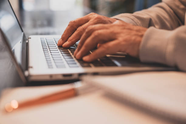 istock Senior woman's hands typing on laptop keyboard sitting at table - online course, learning, e-commerce activity, job 1465643188