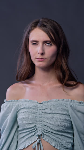Vertical Portrait of Young Woman Looking Annoyed and Rolling Her Eyes