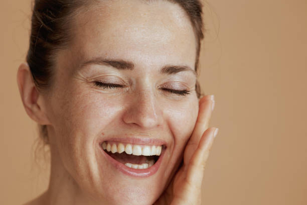 istock smiling modern female with wet face washing 1465647980