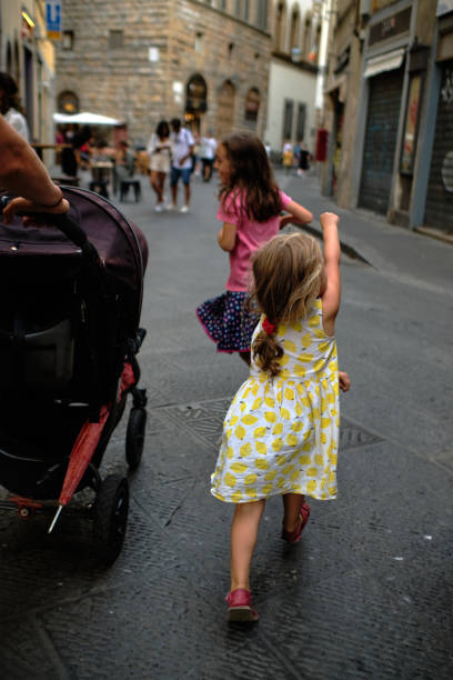 istock Two small sisters run to explore Florence Old town 1465648182