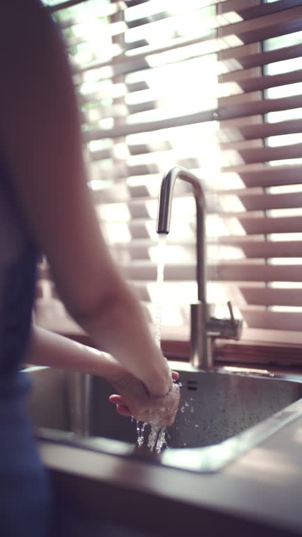 Wash hands in the kitchen sink