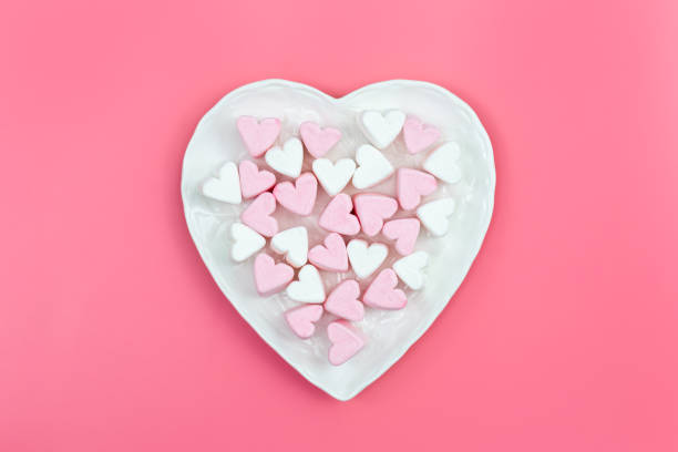 istock Heart shaped plate with heart shaped marshmallows, flat lay. 1465649610