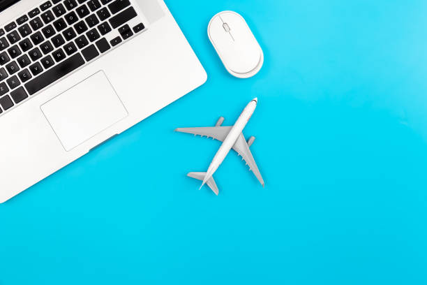 istock Laptop and airplane miniature on blue background, flat lay, copy space. 1465649615