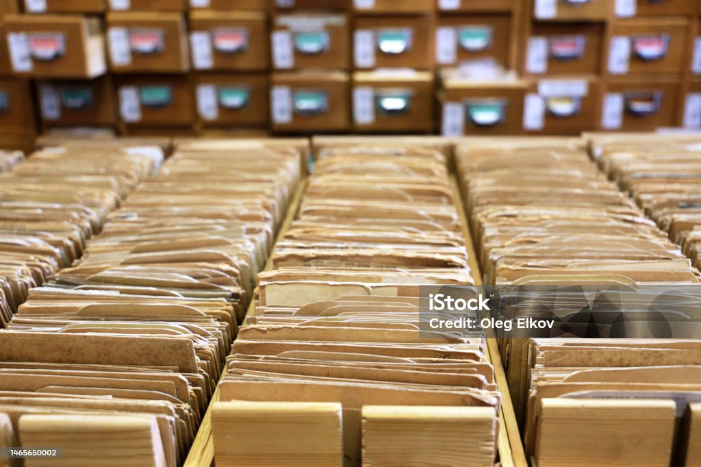 Library catalogue cards in old wooden box File archive, opened drawers with paper documents, database concept Archival Stock Photo