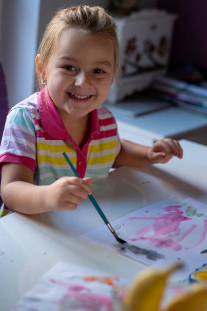 istock A little girl paints with water crayons 1465650538