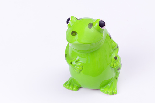 Cute ceramic frog figurine with copy space