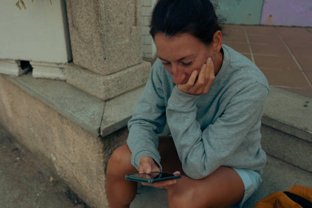 istock A brooding girl with a phone in her hands sits waiting. 1465650985