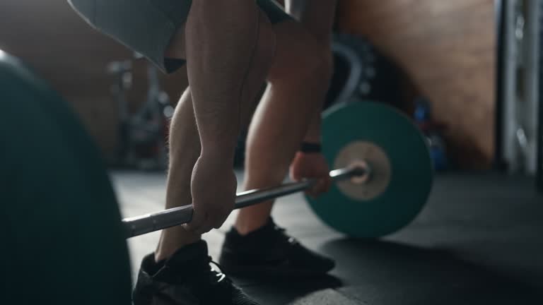 SLO MO Close-up Muscular man doing deadlifts